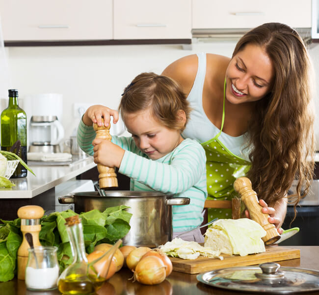 mother toddler kitchen helping