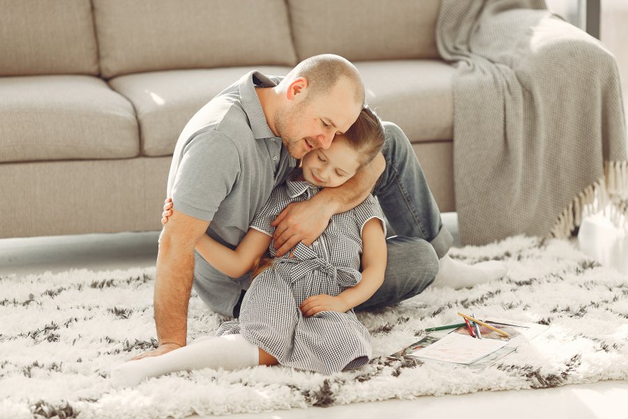 man-hugging-her-daughter