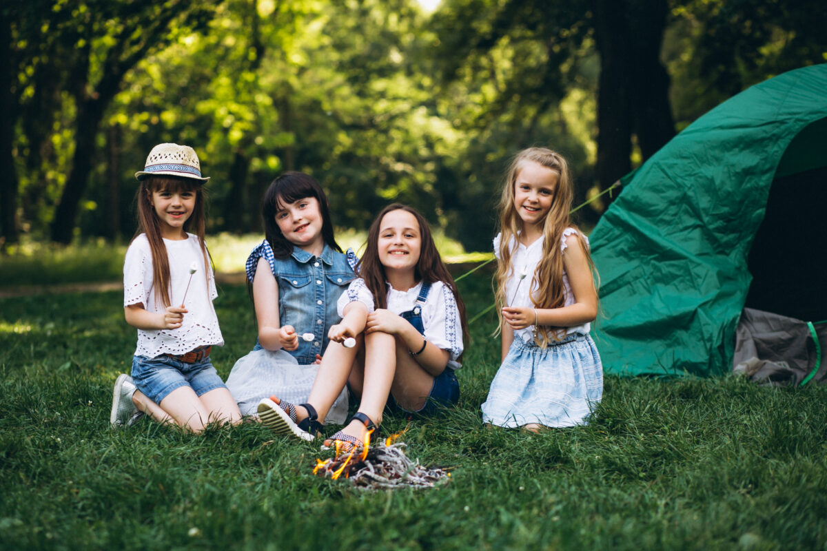Group of girls tourists by the tent in forest